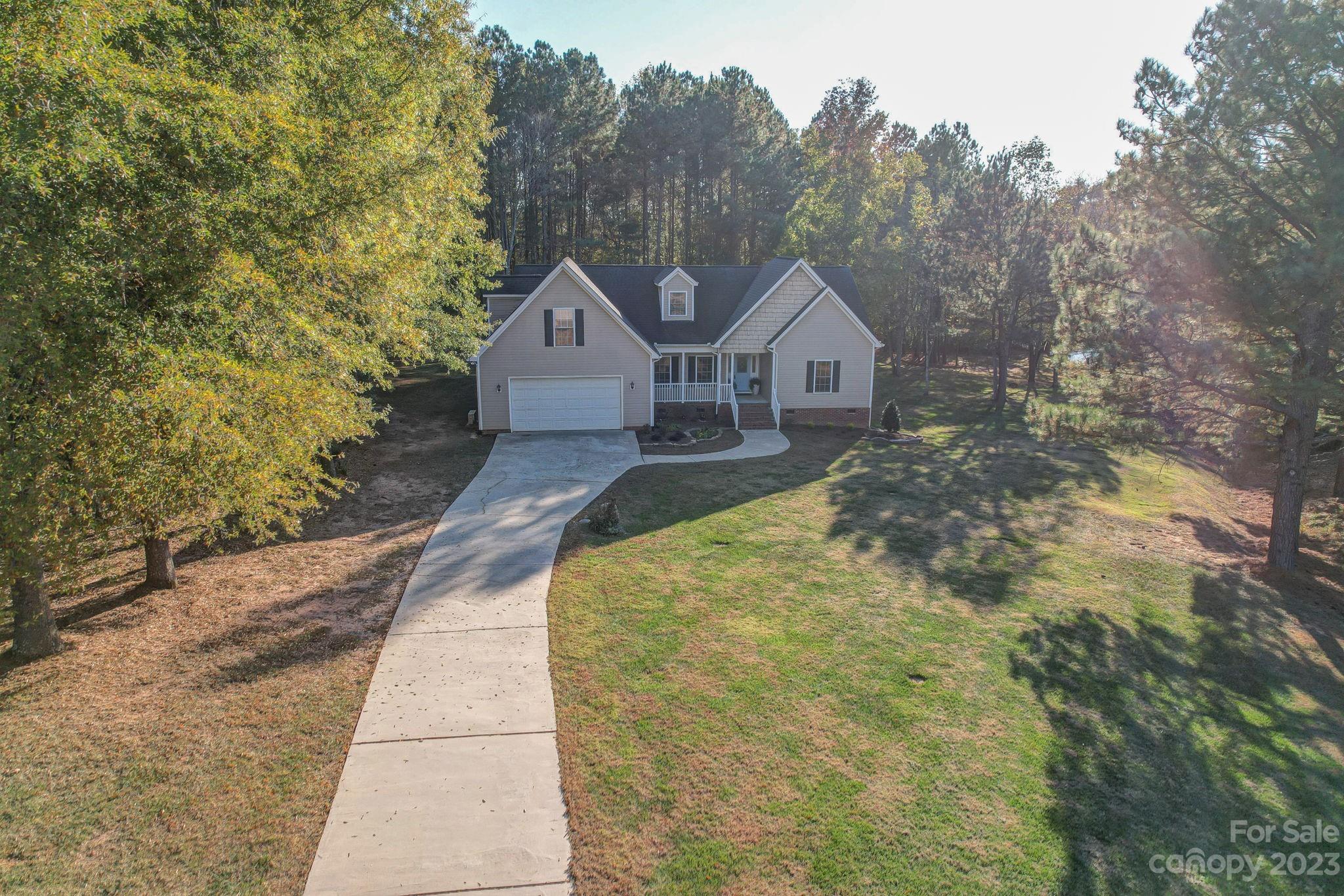 2011 Roadrunner Road Clover, SC 29710 - Photo 44 of 48 a front view of a house with a yard and large trees