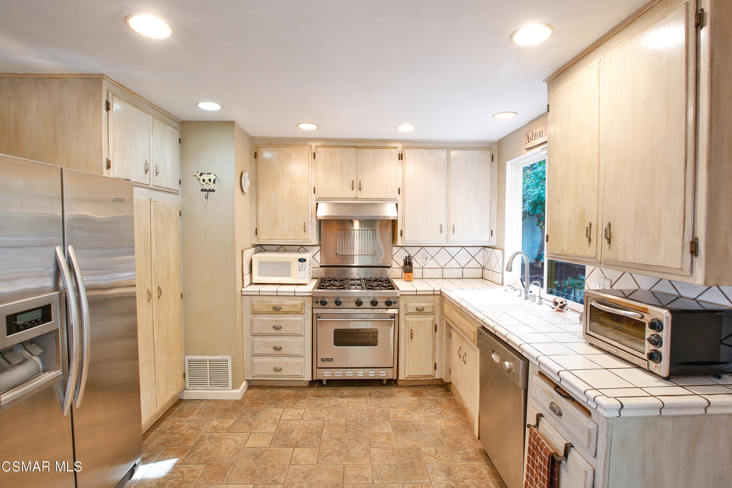 807 Talbert Avenue Simi Valley, CA 93065 - Photo 11 of 33 a kitchen with a stove top oven and refrigerator