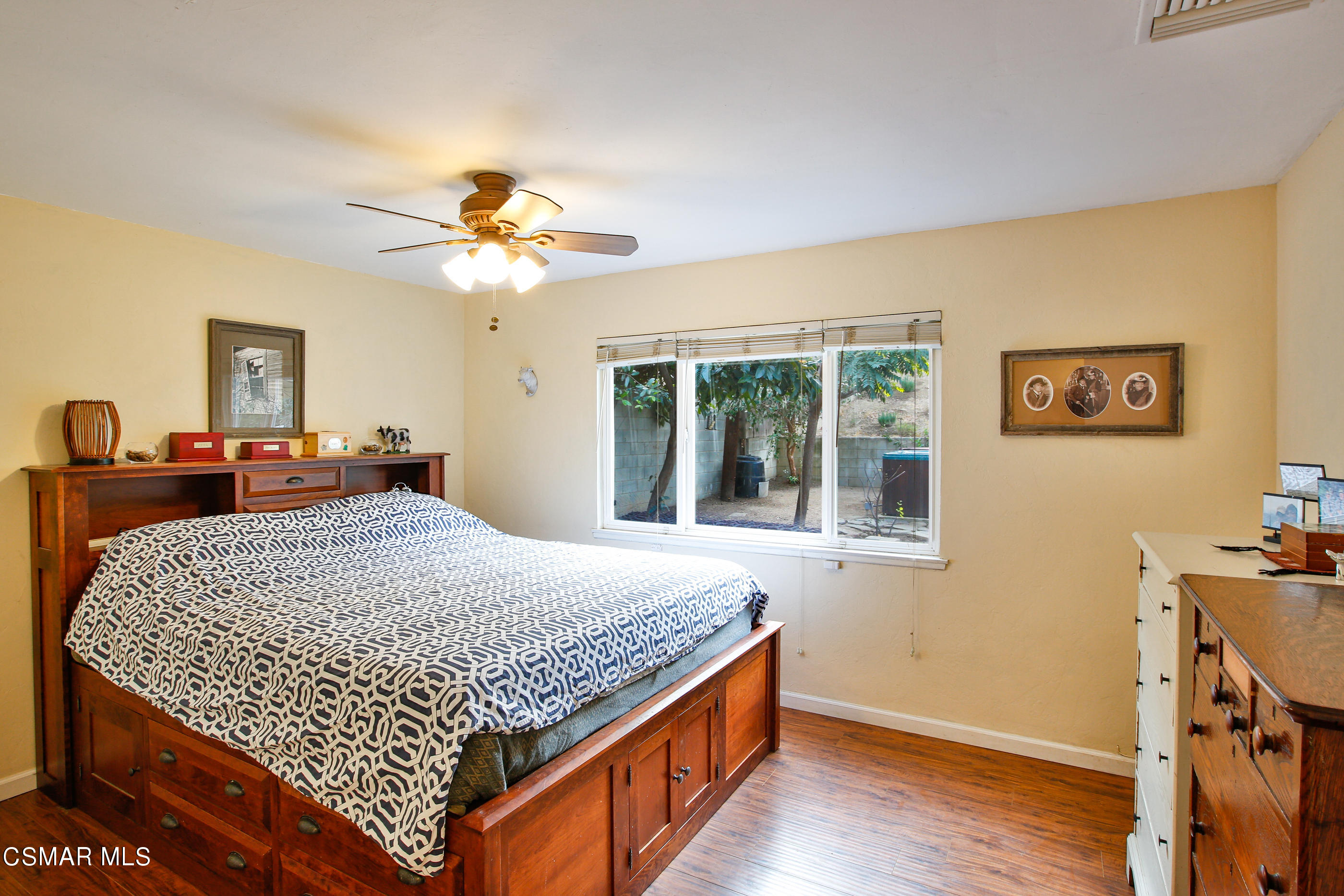 807 Talbert Avenue Simi Valley, CA 93065 - Photo 18 of 33 a bedroom with a bed and a chandelier