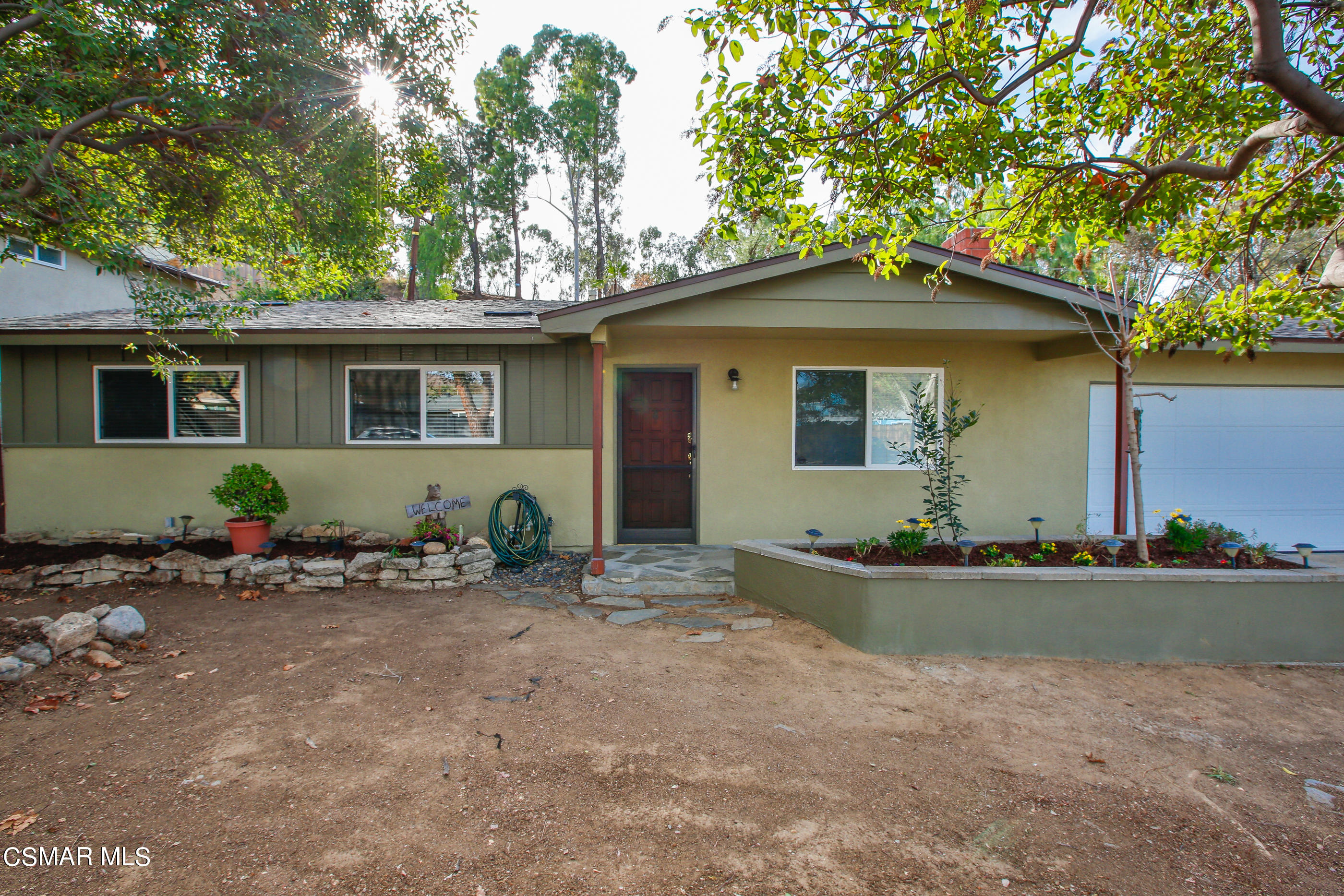 807 Talbert Avenue Simi Valley, CA 93065 - Photo 4 of 33 a backyard of a house with potted plants and a large tree