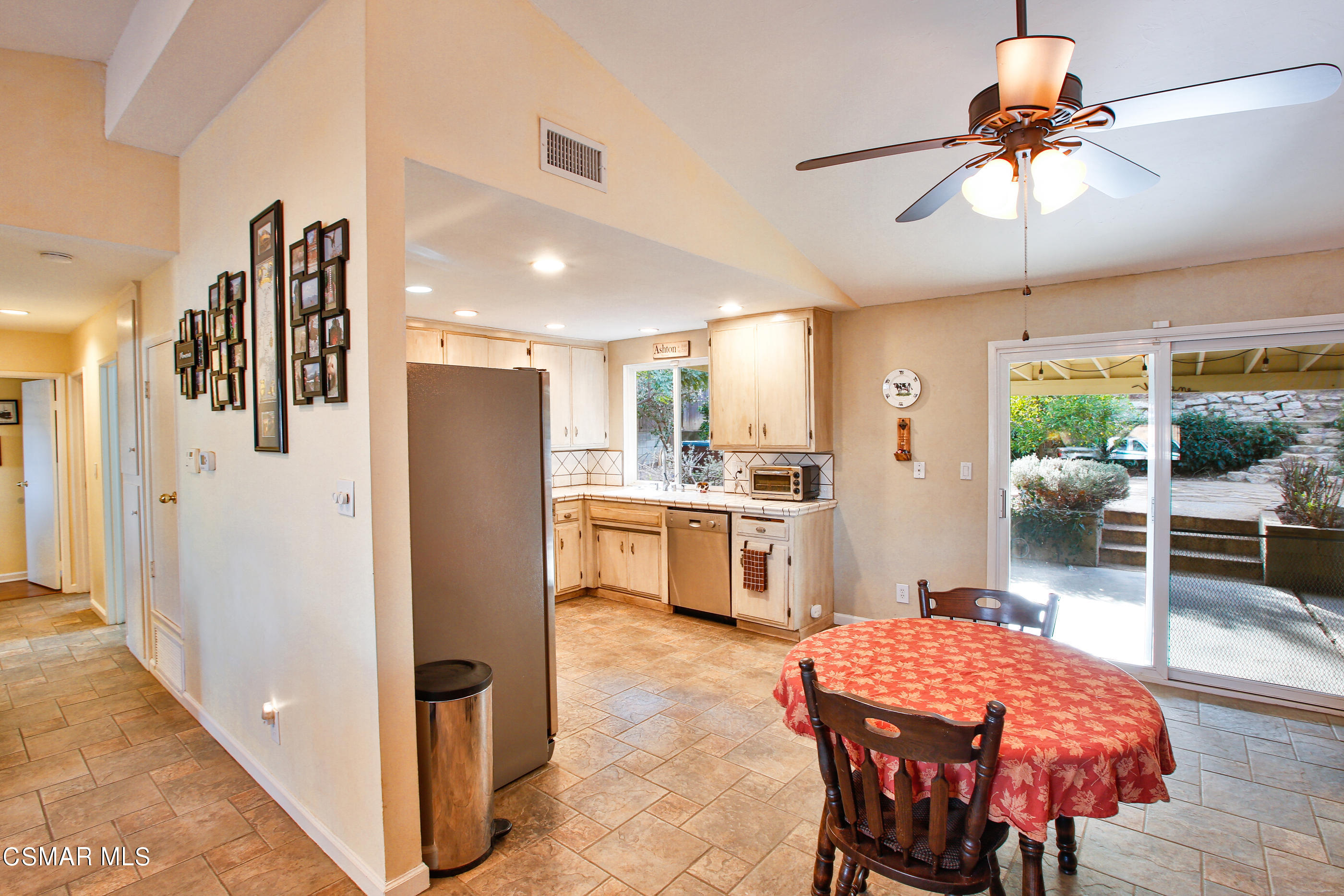 807 Talbert Avenue Simi Valley, CA 93065 - Photo 9 of 33 a kitchen with stainless steel appliances kitchen island granite countertop a refrigerator a stove a sink a dining table and chairs with wooden floor