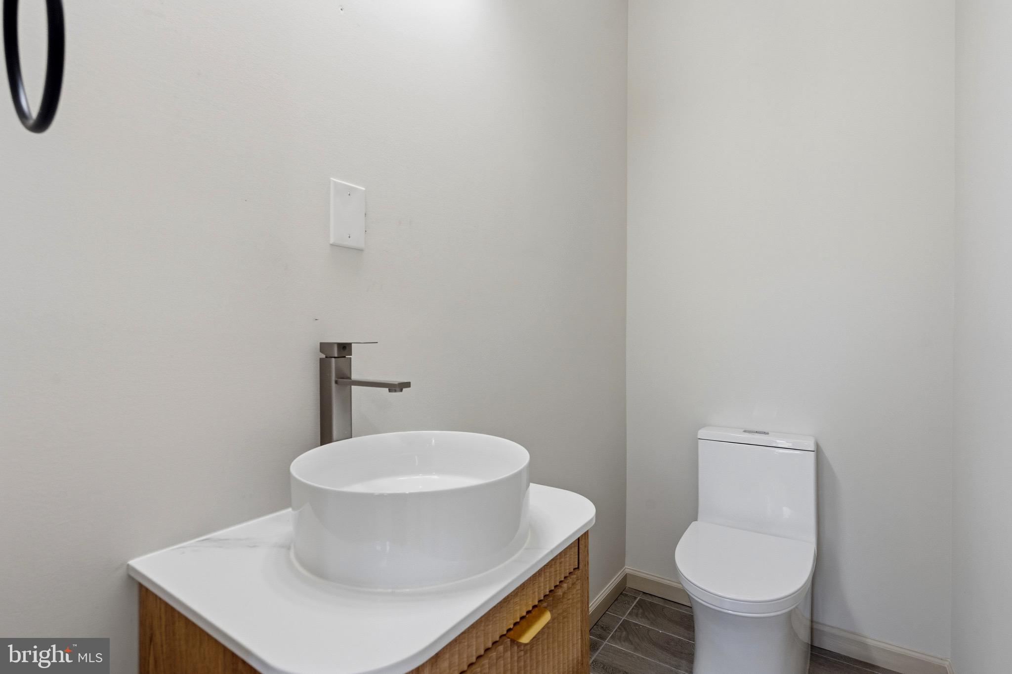 24035 New Mountain Road Aldie, VA 20105 - Photo 110 of 118 a white toilet sitting next to a bathroom sink