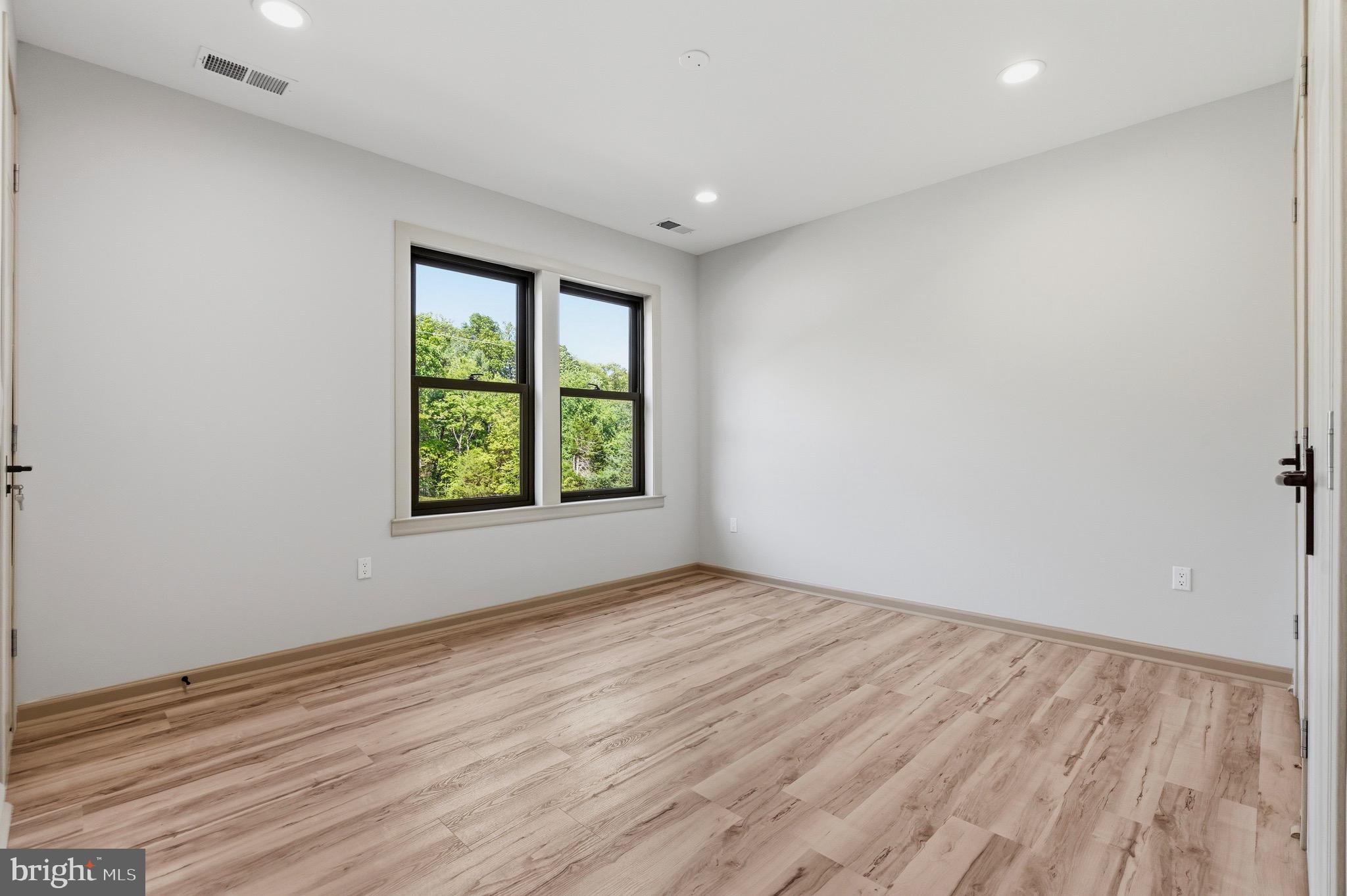 24035 New Mountain Road Aldie, VA 20105 - Photo 112 of 118 a view of an empty room with wooden floor and a window