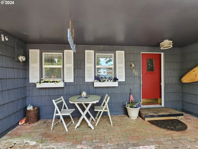 a view of a house with outdoor seating space
