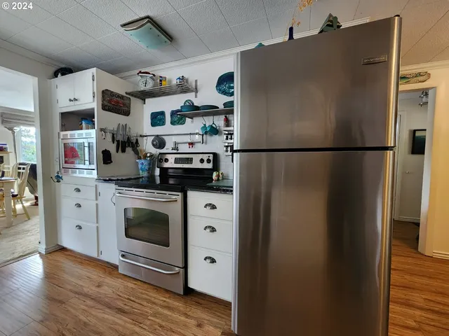 a white refrigerator freezer sitting inside of a kitchen
