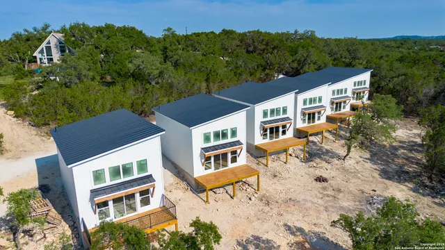 an aerial view of a house with yard