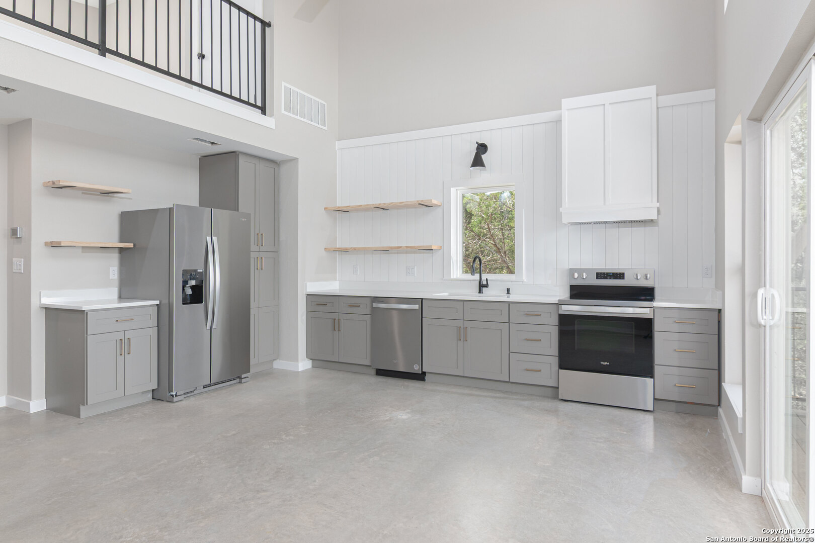 2004 Cedar Hill Drive, Unit 5 Spring Branch, TX 78070 - Photo 5 of 27 a kitchen with a refrigerator and a stove top oven