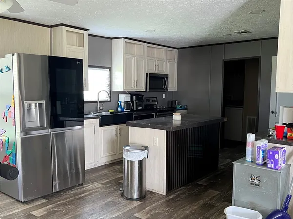 a kitchen with a refrigerator sink and microwave