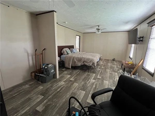 a bed room with a bed and a chair