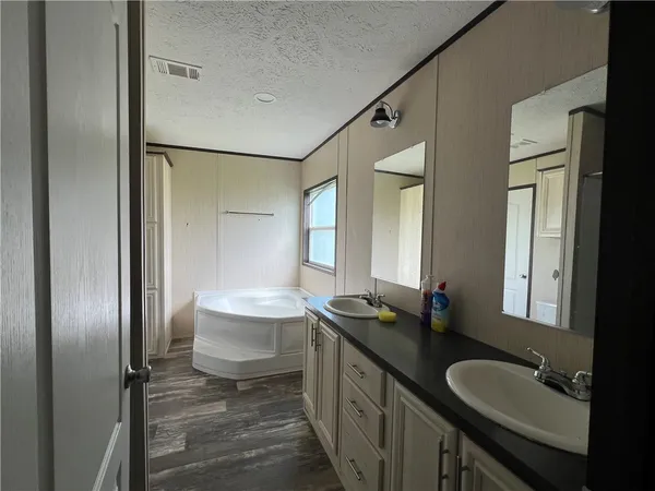 a bathroom with a double vanity sink and a mirror
