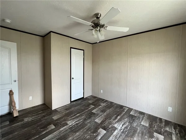 a view of a livingroom with a ceiling fan and wooden floor