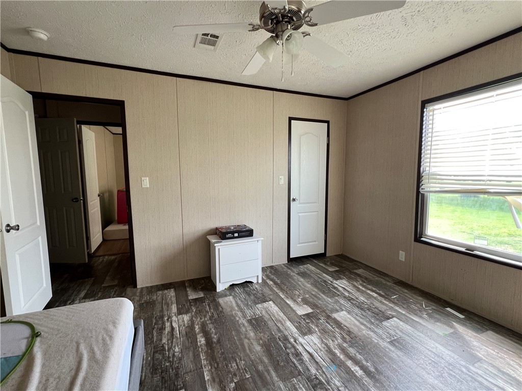 1903 1st Street Bayside, TX 78340 - Photo 28 of 38 a bedroom with a bed and a chandelier