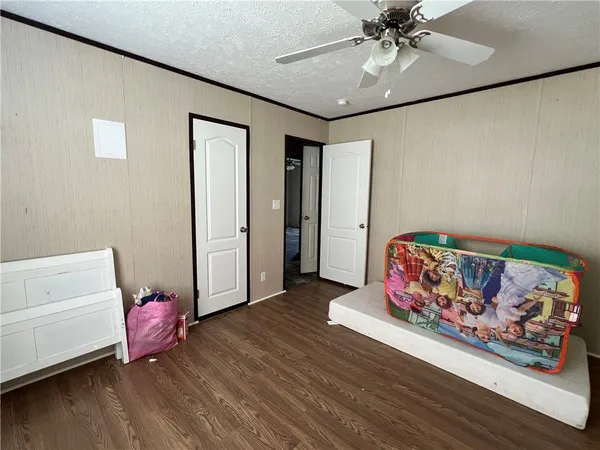 a bedroom with furniture and wooden floor