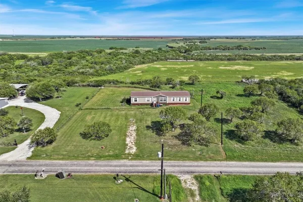 a view of a field with an ocean view