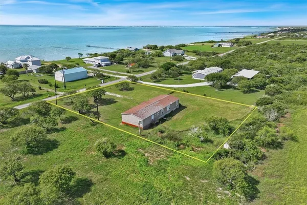 a view of a field with an ocean