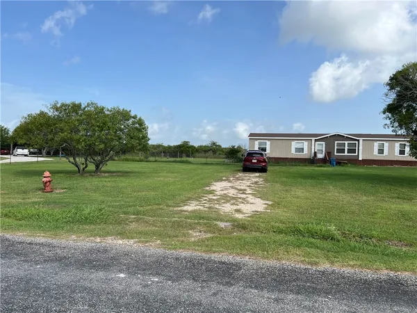 a view of a house with a big yard