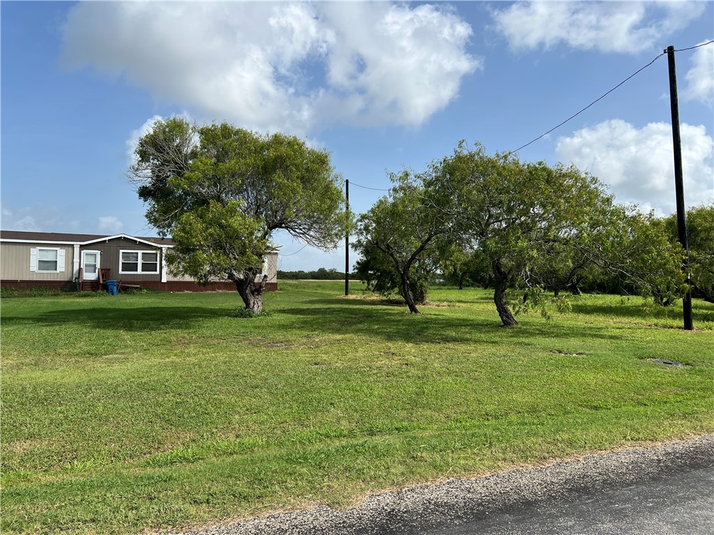 1903 1st Street Bayside, TX 78340 - Photo 6 of 38 a backyard of a house with lots of green space and fountain
