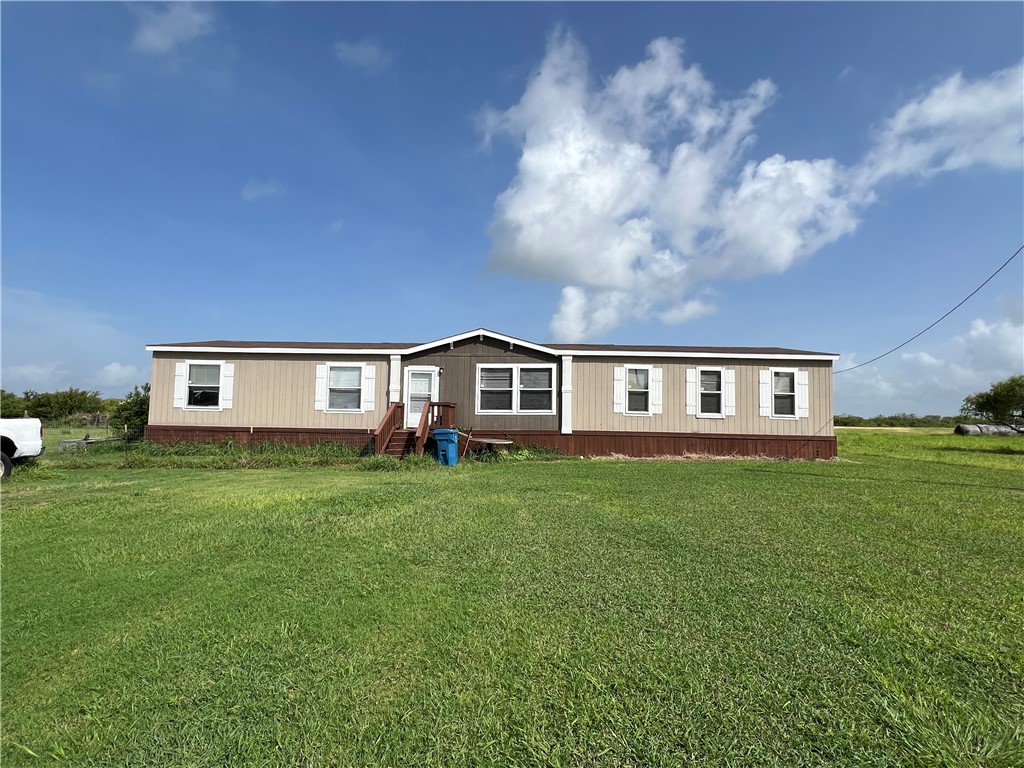1903 1st Street Bayside, TX 78340 - Photo 7 of 38 a front view of a house with a garden