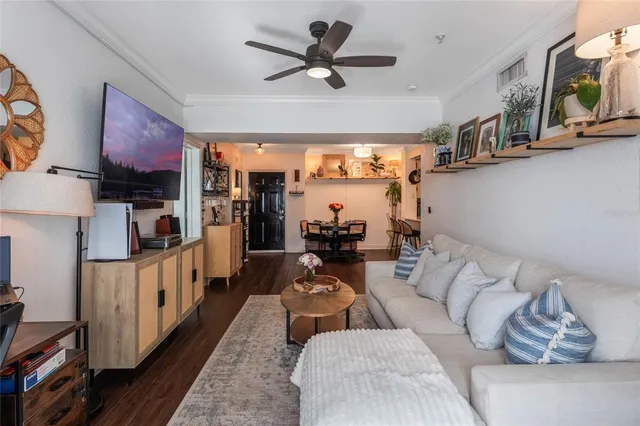 a living room with furniture a air conditioner and a window