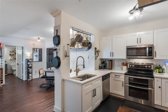 a kitchen with stainless steel appliances granite countertop a sink and cabinets