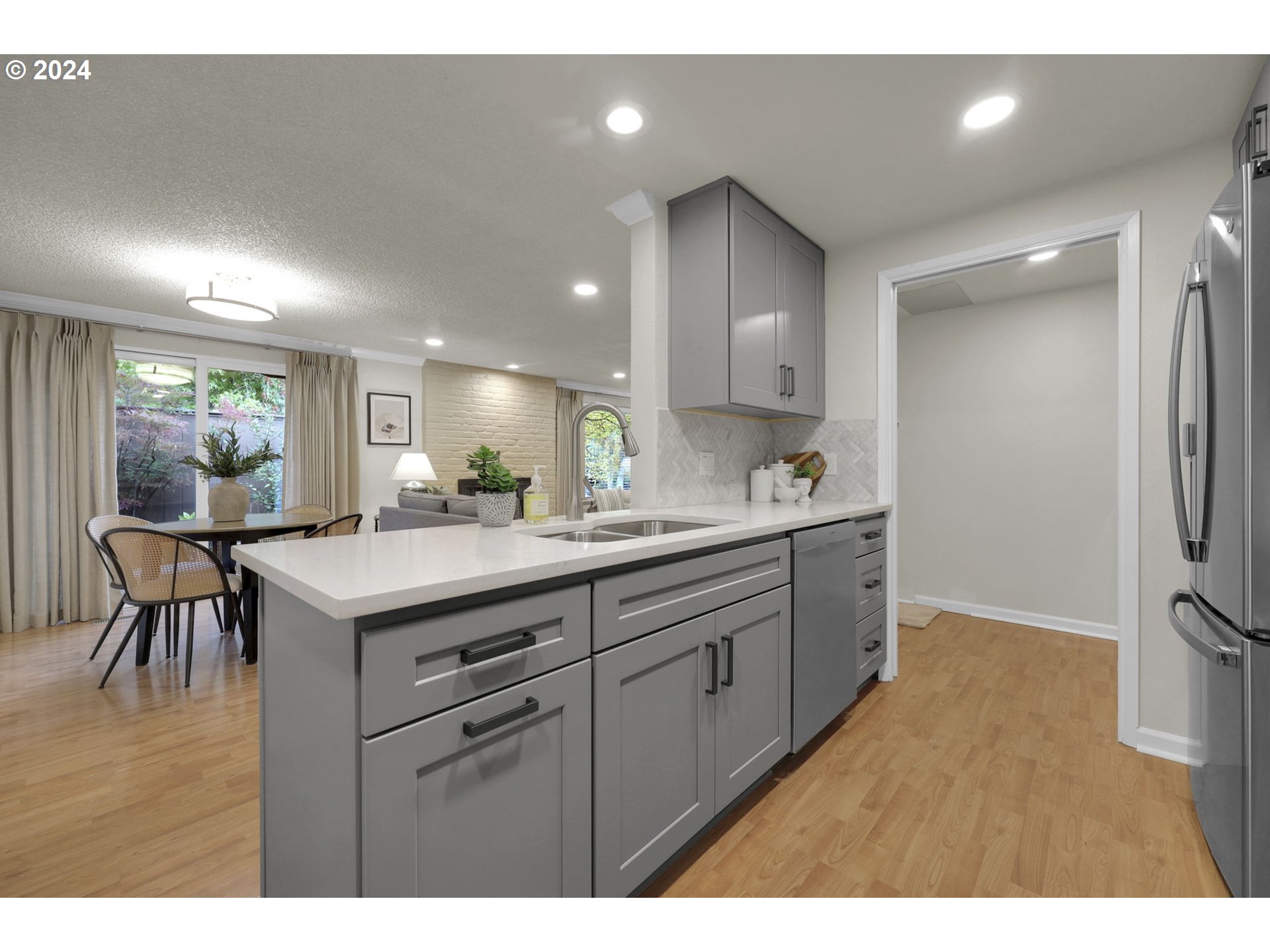 100 Westbrook Way Eugene, OR 97405 - Photo 17 of 48 a kitchen with a sink a refrigerator and chairs
