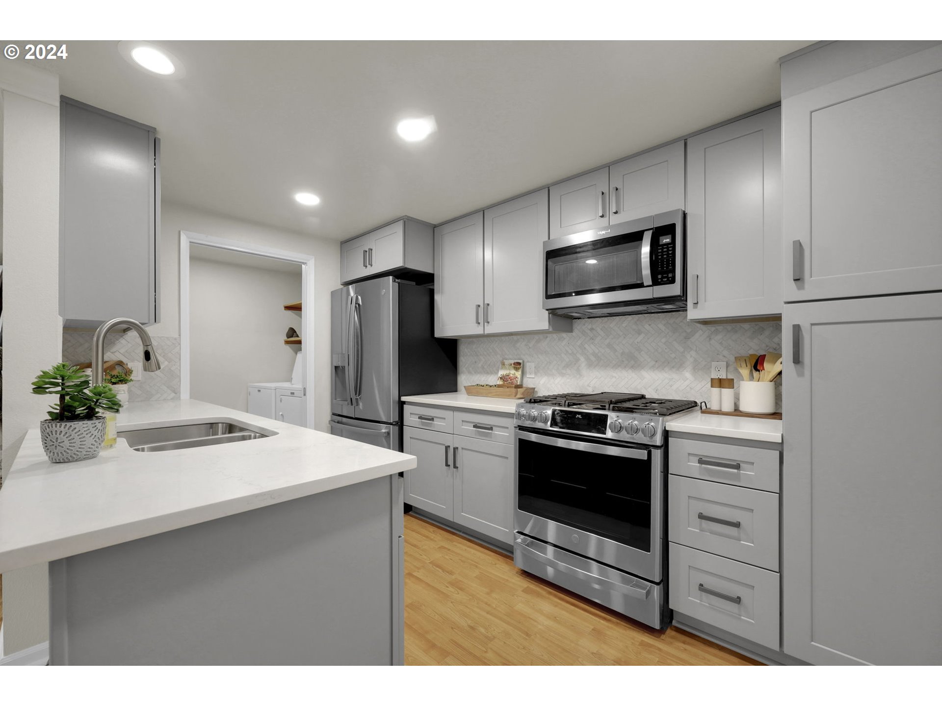 100 Westbrook Way Eugene, OR 97405 - Photo 23 of 48 a kitchen with stainless steel appliances a stove sink microwave and refrigerator