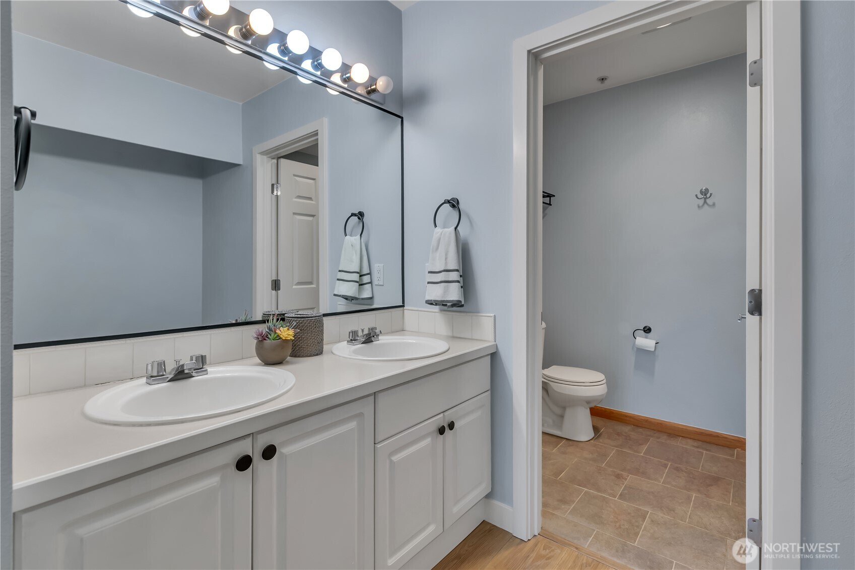 15310 Macadam Road South, Unit A204 Tukwila, WA 98188 - Photo 18 of 25 a bathroom with a granite countertop sink a toilet and a mirror
