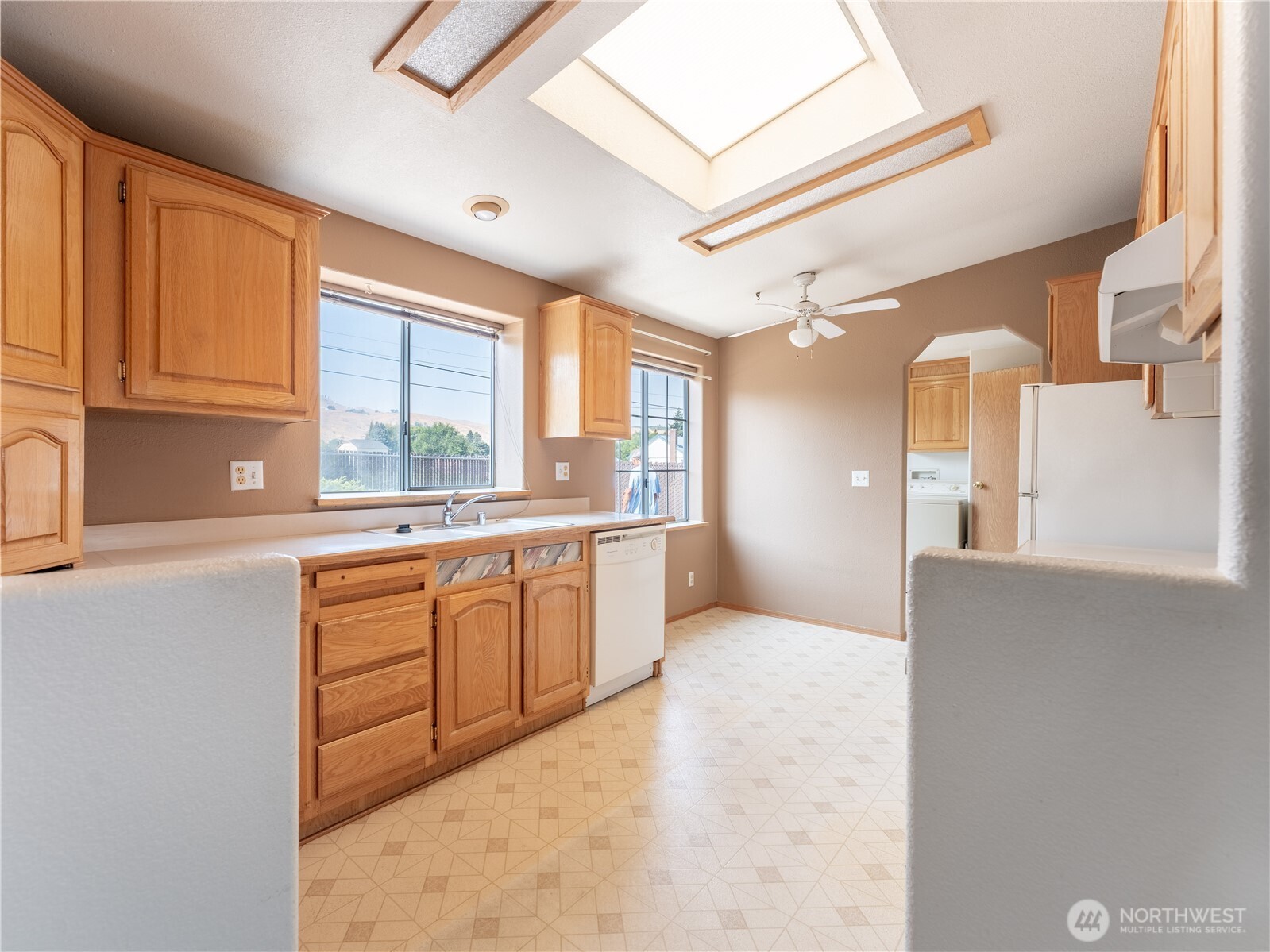 914 Meadow Ridge Drive Wenatchee, WA 98801 - Photo 24 of 35 a large white kitchen with cabinets a sink a window and a counter top space