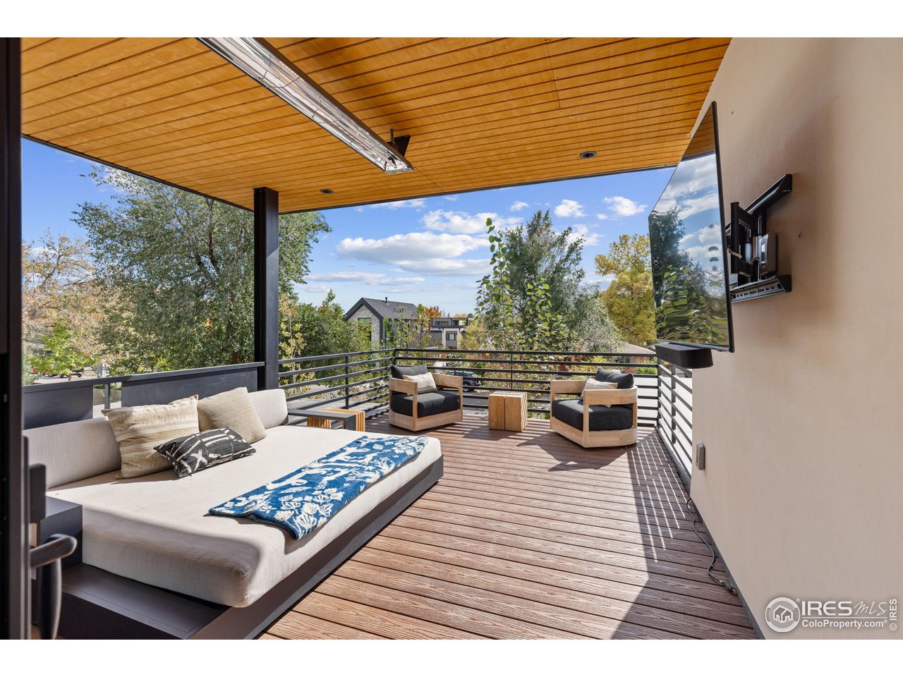 2125 Upland Avenue Boulder, CO 80304 - Photo 18 of 38 a view of a patio with lawn chairs under an umbrella