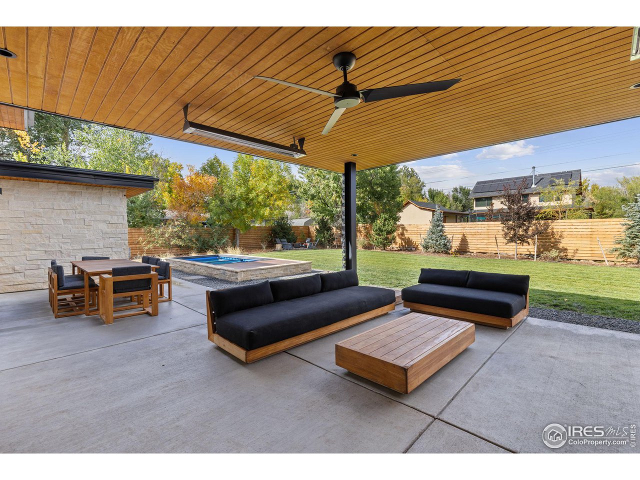 2125 Upland Avenue Boulder, CO 80304 - Photo 21 of 38 a roof deck with a table and chairs under an umbrella