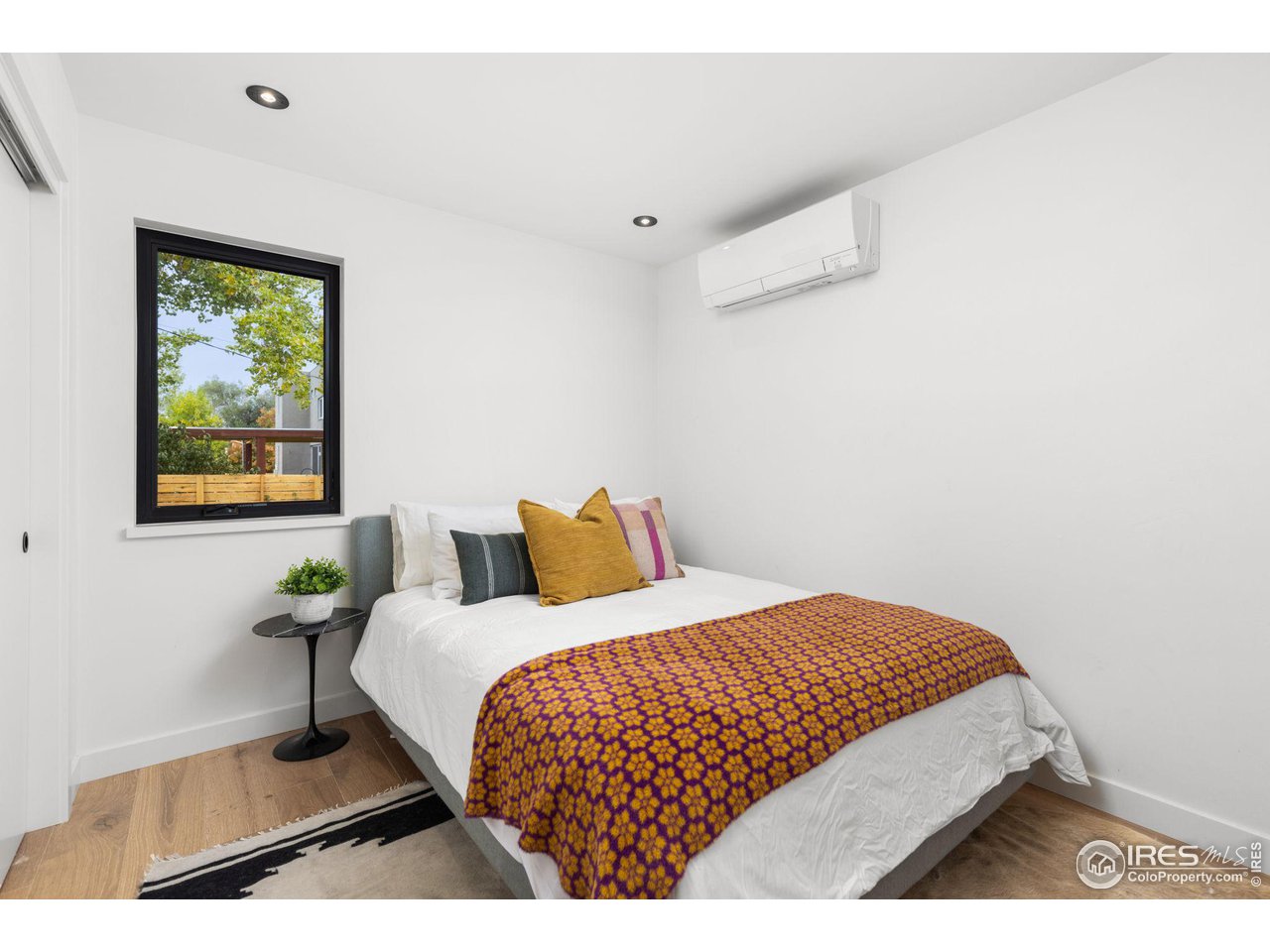 2125 Upland Avenue Boulder, CO 80304 - Photo 30 of 38 a bedroom with a bed and window