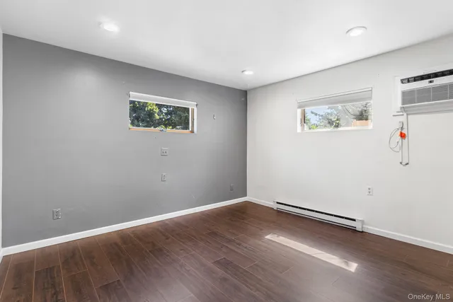 an empty room with wooden floor and closet