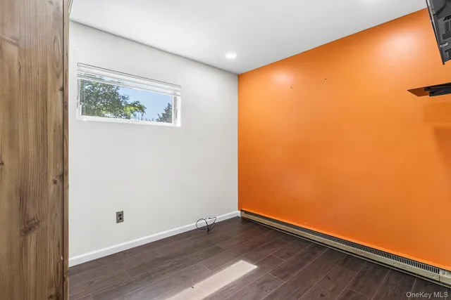 a view of a hallway with wooden floor and closet
