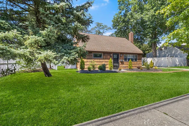 a view of a house with a backyard and a patio