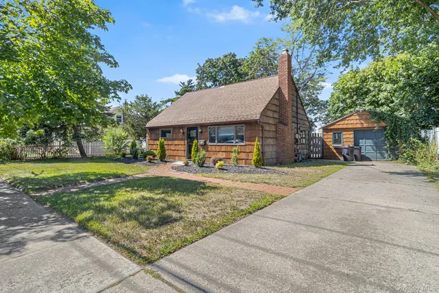 a living room with furniture a large window and a wooden floor