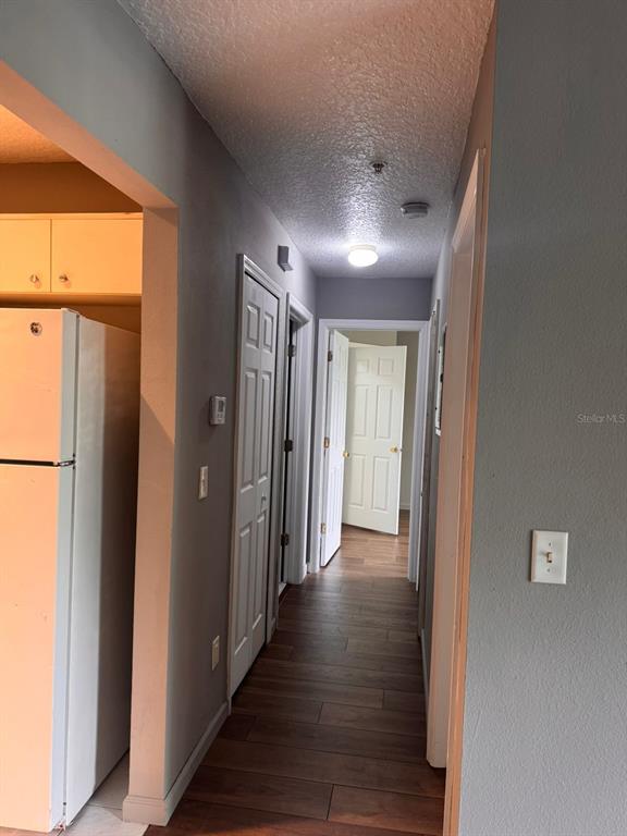 1132 South Pine Ridge Circle, Unit 32 Sanford, FL 32773 - Photo 11 of 26 a view of a hallway with wooden floor