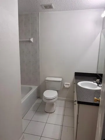 a bathroom with a toilet a sink and bathtub