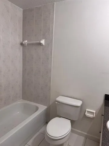 a white toilet and tub
