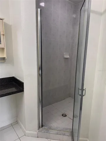 a bathroom with a shower and a sink