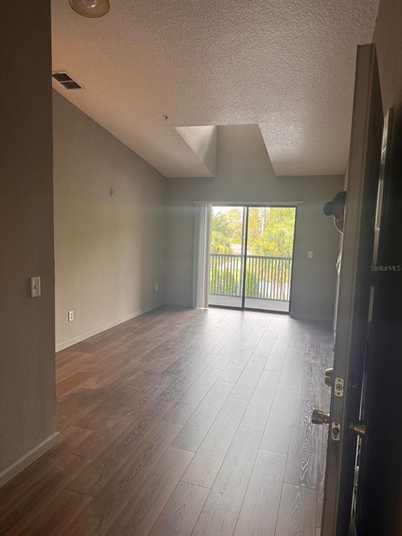 1132 South Pine Ridge Circle, Unit 32 Sanford, FL 32773 - Photo 4 of 26 an empty room with wooden floor and windows