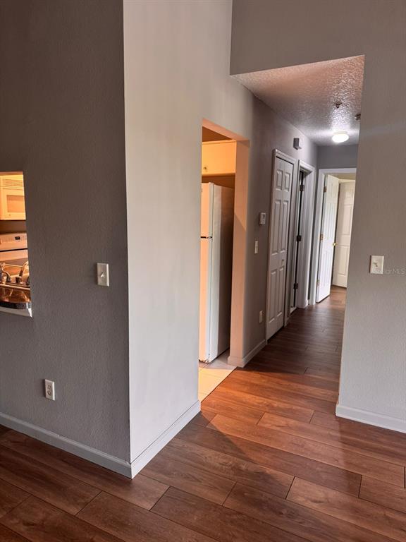 1132 South Pine Ridge Circle, Unit 32 Sanford, FL 32773 - Photo 6 of 26 a view of a hallway with wooden floor