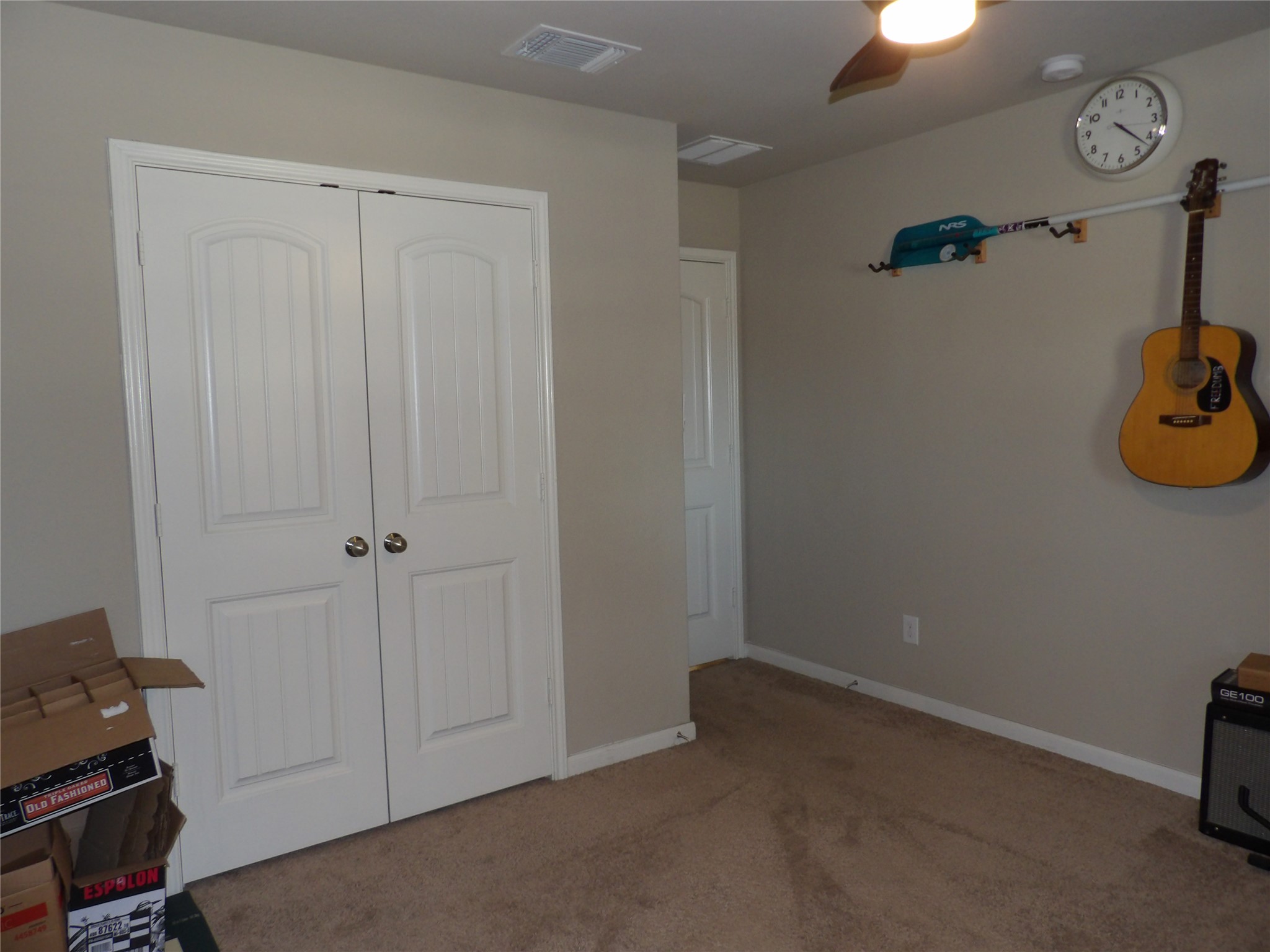 930 Pumpkin Ridge New Braunfels, TX 78130 - Photo 13 of 32 Bedroom featuring neutral painted walls, carpet flooring, a ceiling fan with integrated lighting, and a closet with bifold panel doors