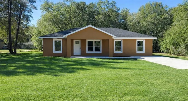 a front view of house with yard and green space