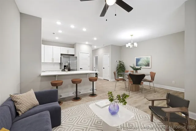 a living room with furniture and kitchen view