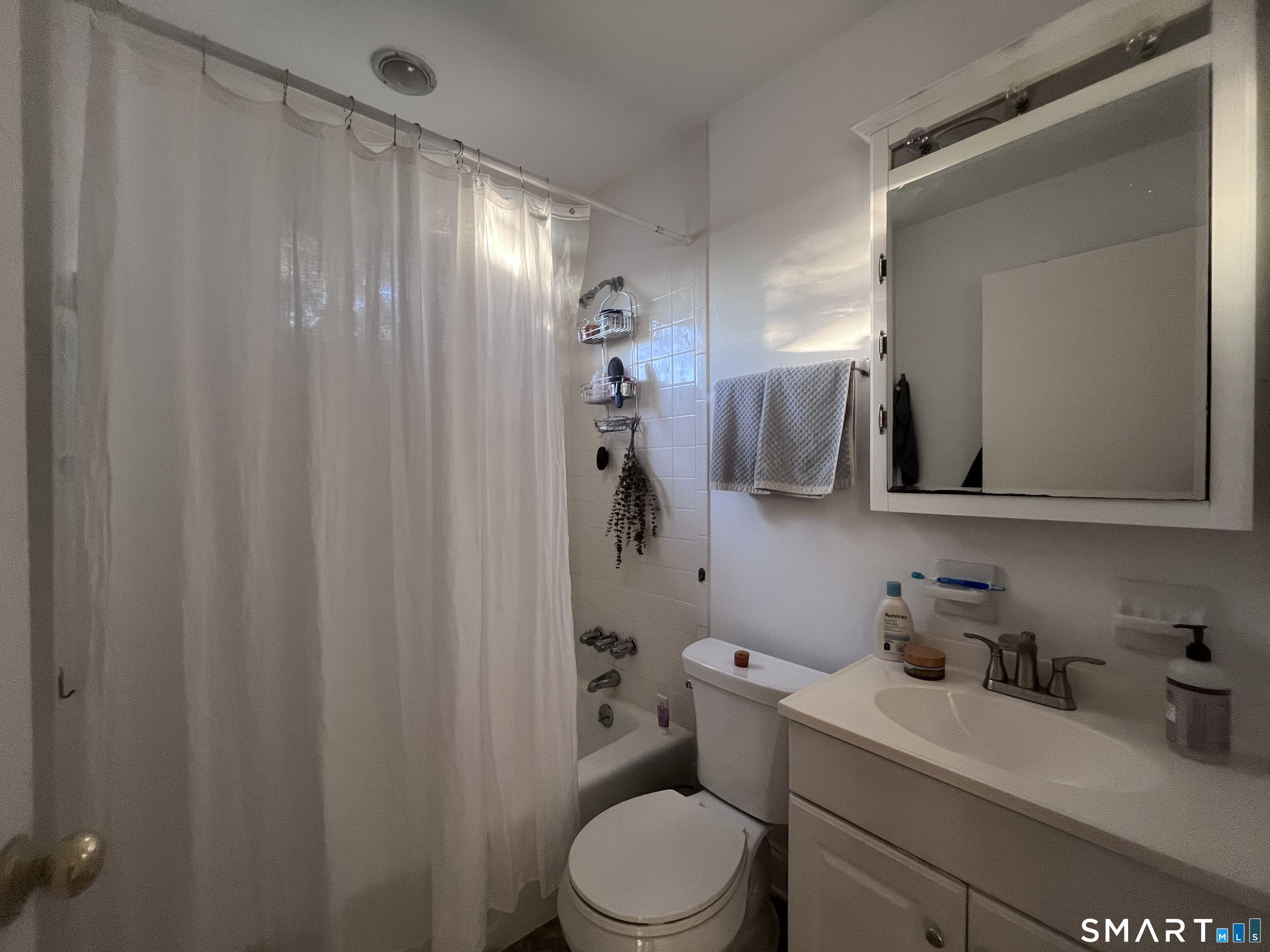 124 Thorpe Street Fairfield, CT 06824 - Photo 18 of 23 a bathroom with a granite countertop sink vanity mirror and toilet