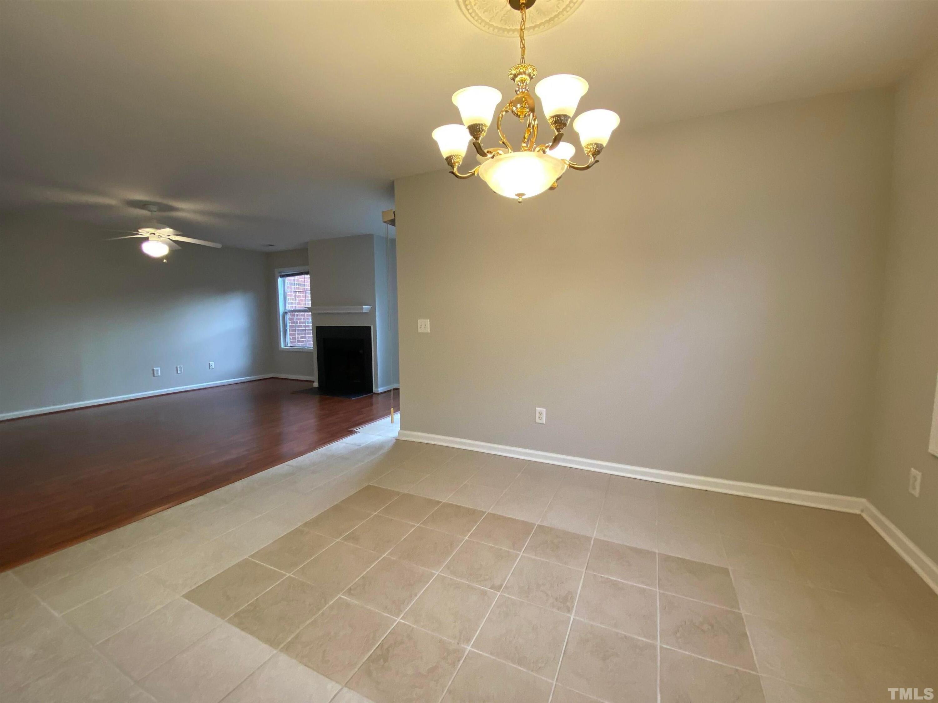 2413 Wellington Ridge Loop, Unit 2413 Cary, NC 27518 - Photo 11 of 30 a view of an empty room with a chandelier fan