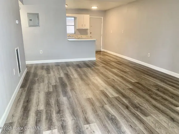 a view of wooden floor and window in a room