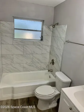 a bathroom with a toilet and a bathtub