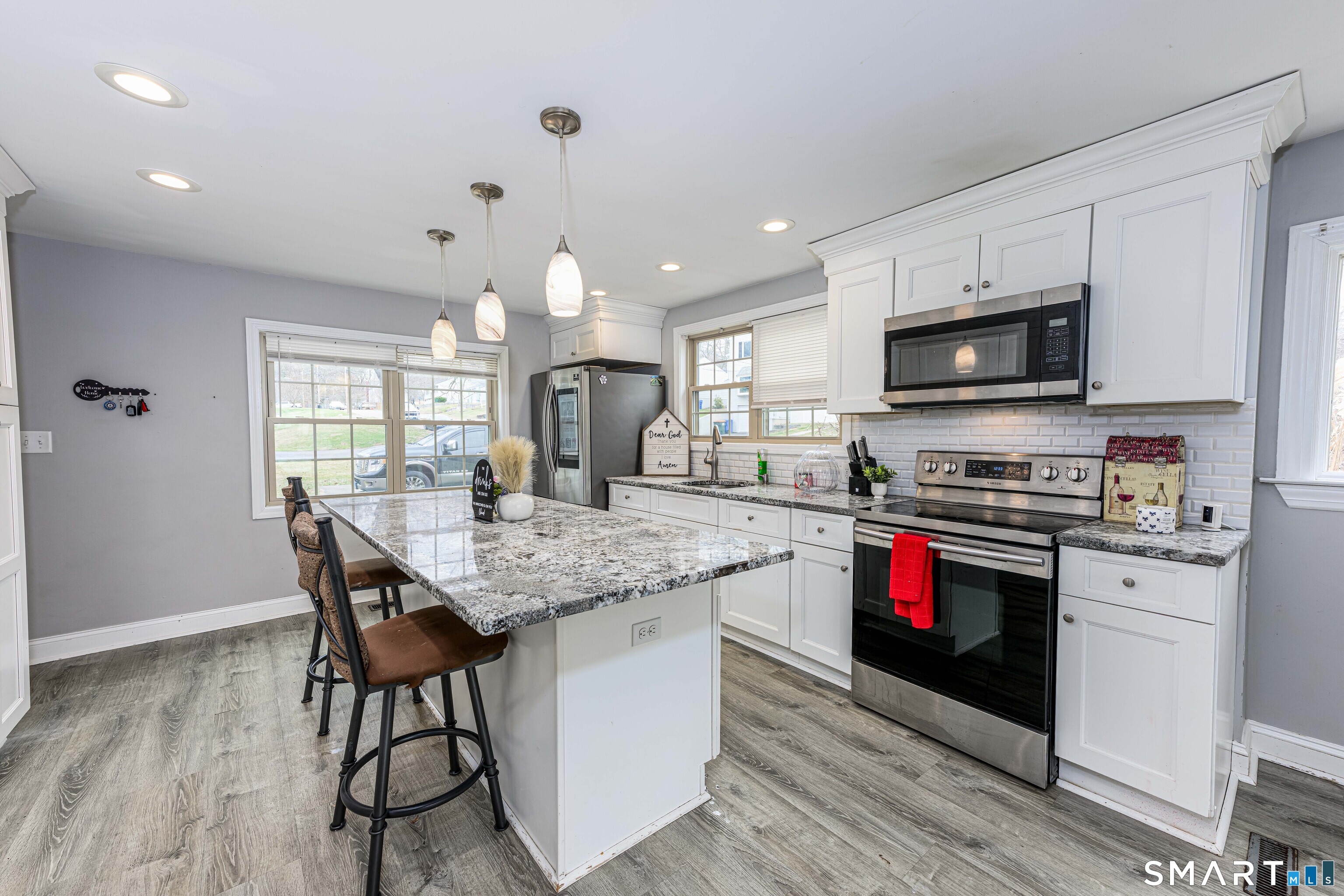 112 Orchard Street Meriden, CT 06450 - Photo 11 of 30 a kitchen with stainless steel appliances granite countertop a stove top oven a sink dishwasher and a microwave oven on the wooden floor