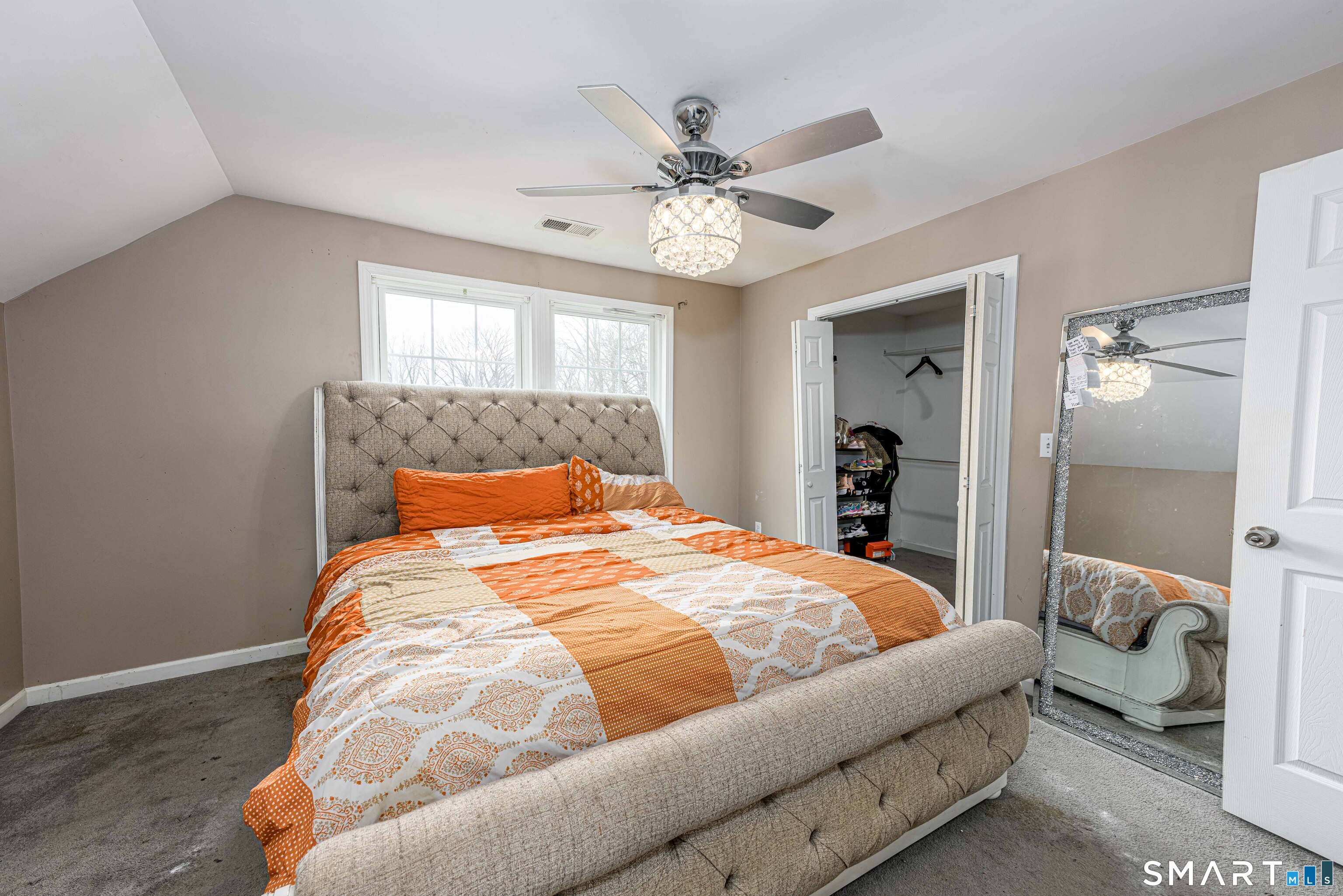 112 Orchard Street Meriden, CT 06450 - Photo 13 of 30 a bedroom with a bed and a chandelier